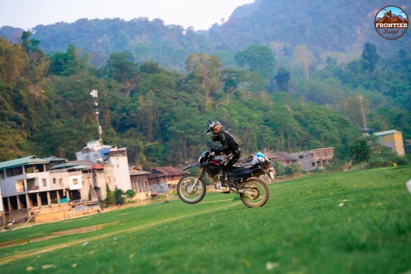 Tipping guide Vietnam motorbike tour guide mechanic shows appreciation for safe support